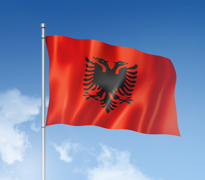 Albanian flag isolated on a blue sky. Horizontal banner
